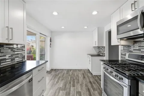 a kitchen with a stove and a refrigerator