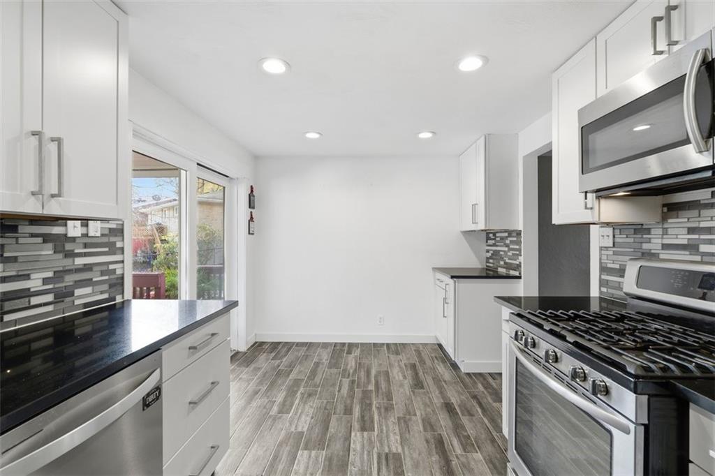 4576 Gates Drive Homestead, PA 15120 - Photo 6 of 17 a kitchen with a stove and a refrigerator
