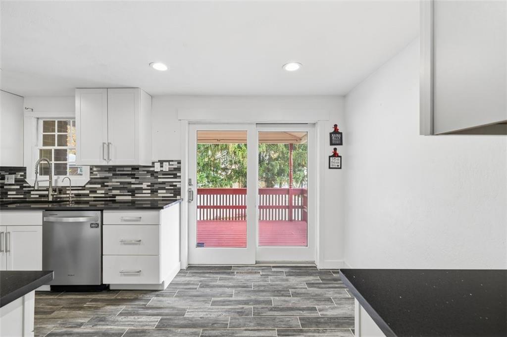4576 Gates Drive Homestead, PA 15120 - Photo 7 of 17 a kitchen with stainless steel appliances granite countertop a stove a sink and a microwave