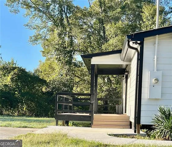 a view of a door of the house and a yard