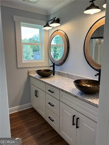 a bathroom with a granite countertop toilet a sink and a mirror