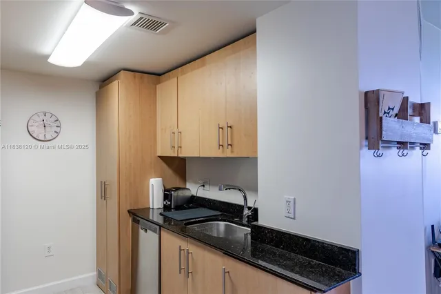 a kitchen with a refrigerator and a stove