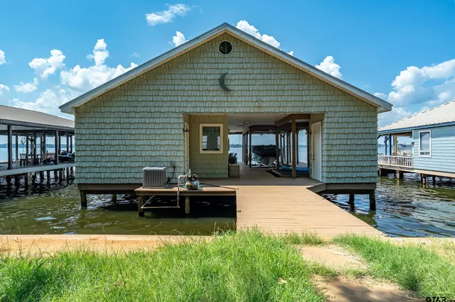 a front view of a house with swimming pool having outdoor seating