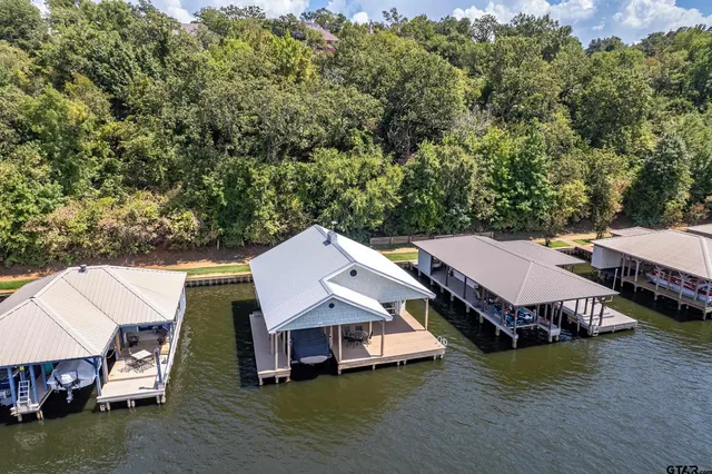 an aerial view of a house with garden space and boat