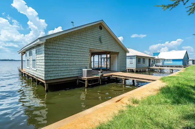 a view of a house with swimming pool and sitting area