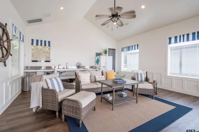 a living room with lots of furniture and a chandelier