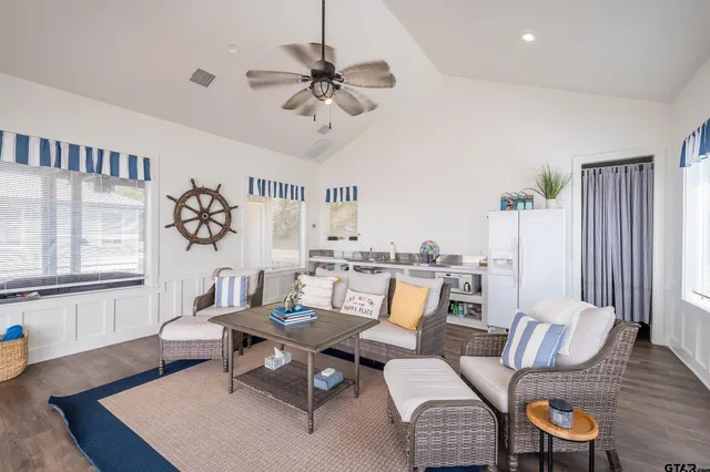 a living room with furniture and wooden floor