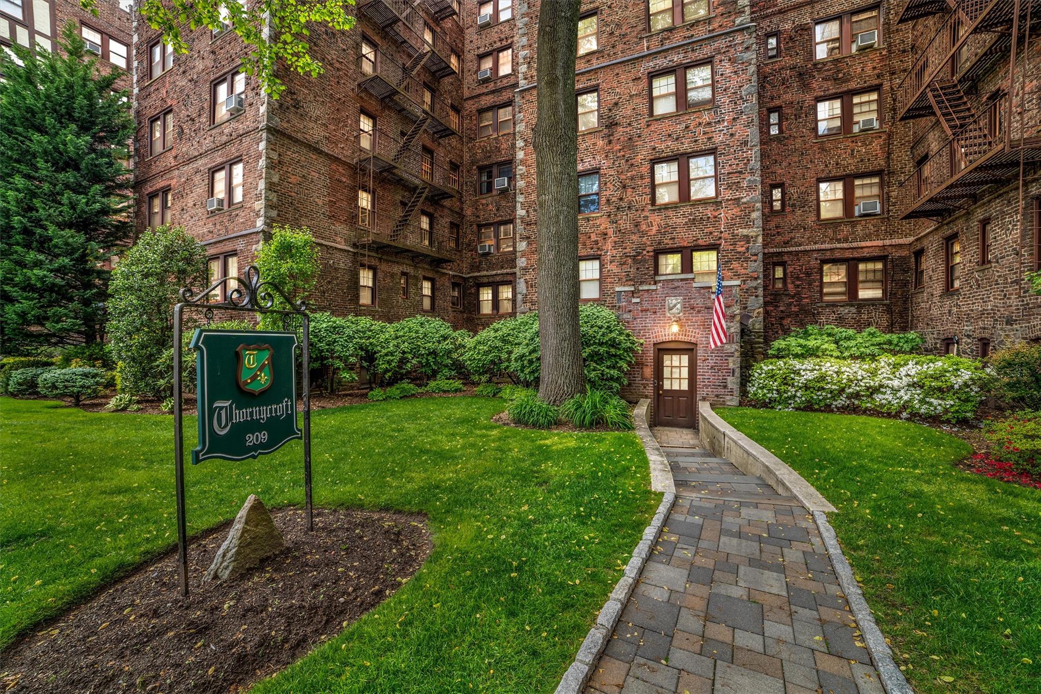 a front view of a building with garden
