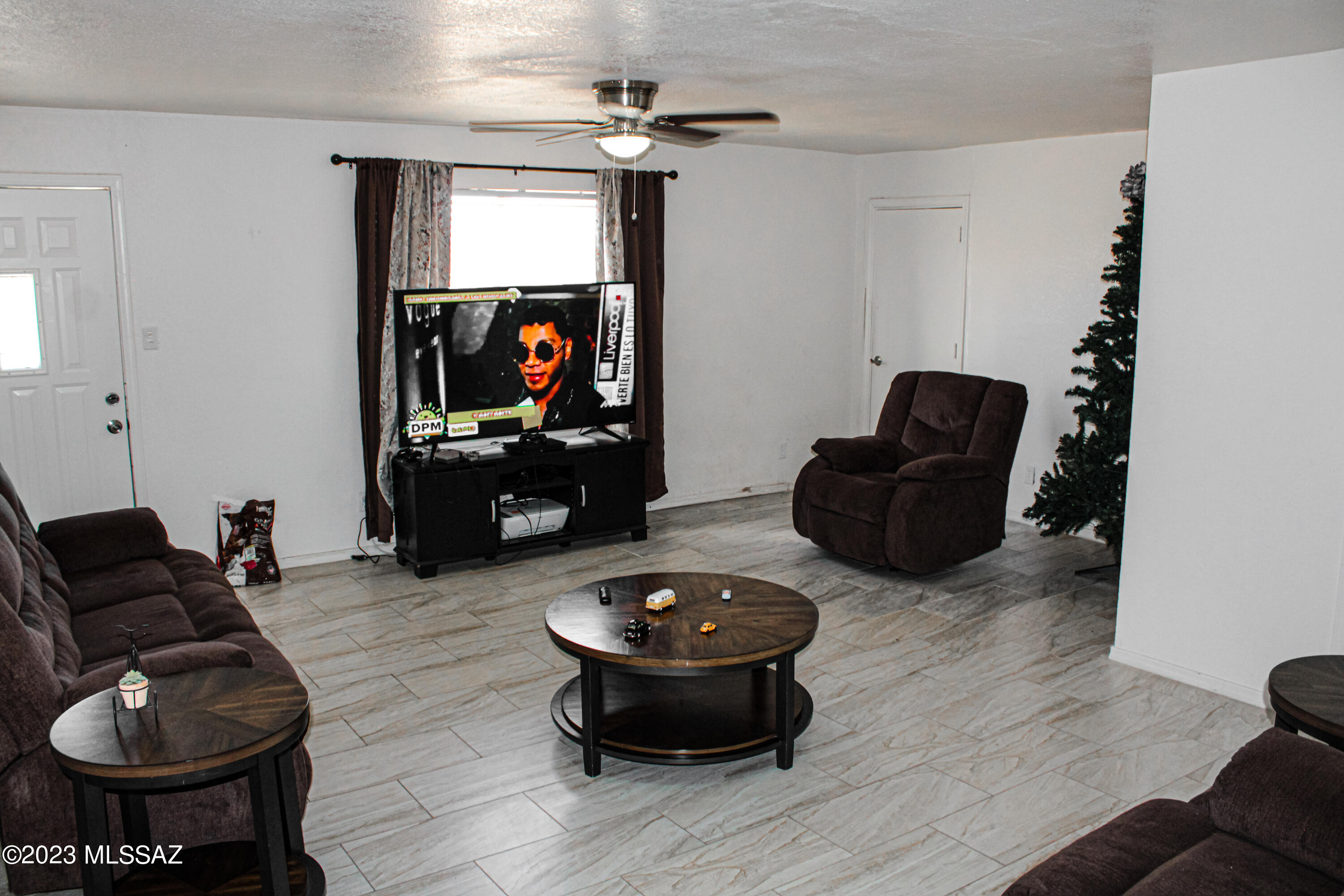 282 Paseo Mascota Rio Rico, AZ 85648 - Photo 10 of 18 a living room with furniture and a flat screen tv