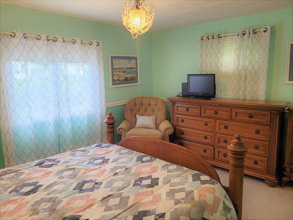 62 Longboat Road Wareham, MA 02576 - Photo 17 of 32 a bedroom with a bed and a television
