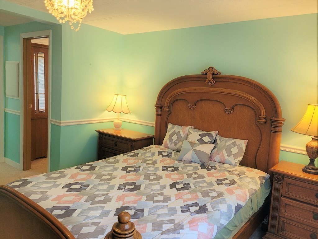 62 Longboat Road Wareham, MA 02576 - Photo 18 of 32 a bedroom with a bed and a mirror