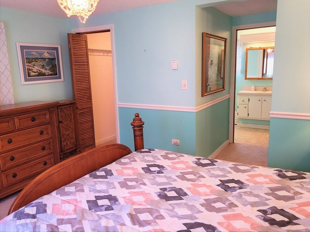 62 Longboat Road Wareham, MA 02576 - Photo 19 of 32 a bedroom with a bed and a cabinets