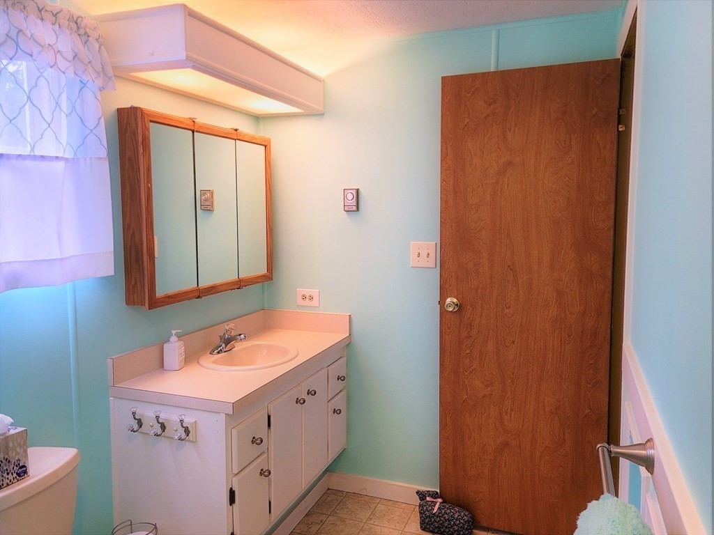 62 Longboat Road Wareham, MA 02576 - Photo 21 of 32 a bathroom with a sink a vanity and a mirror