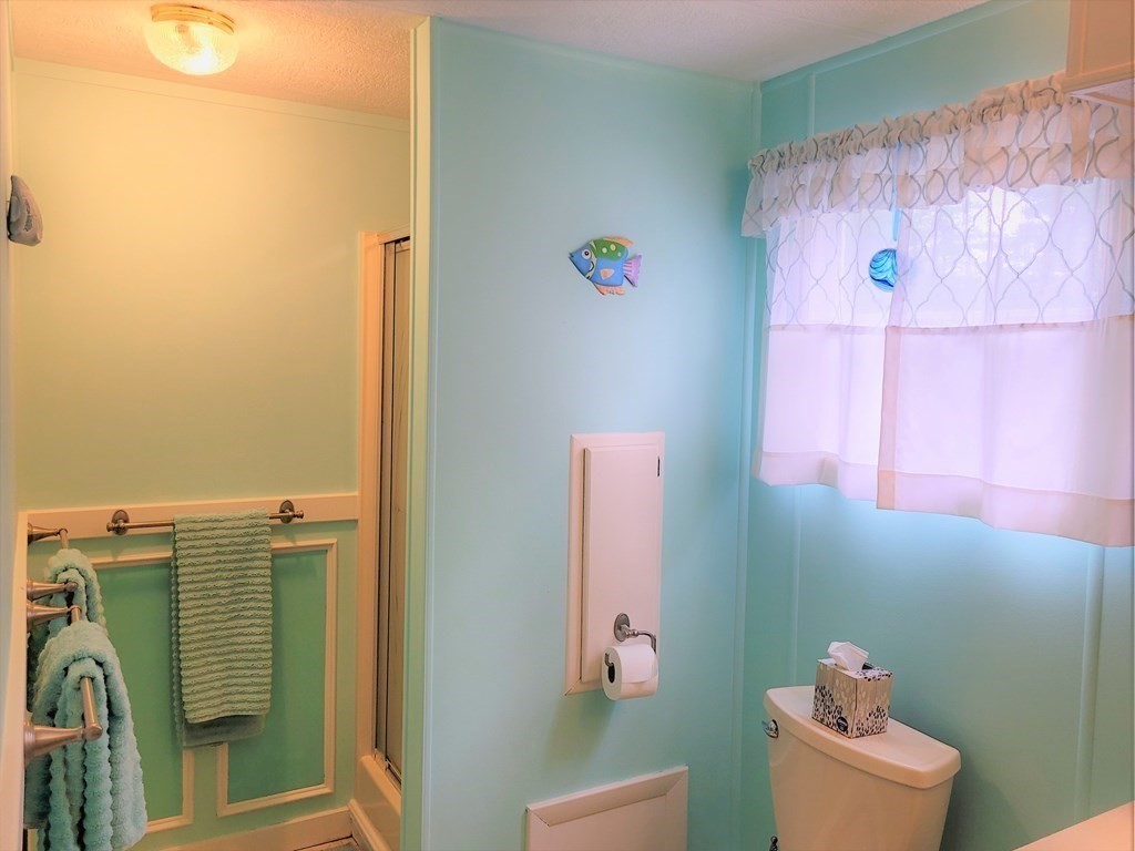 62 Longboat Road Wareham, MA 02576 - Photo 22 of 32 a bathroom with a sink mirror and vanity