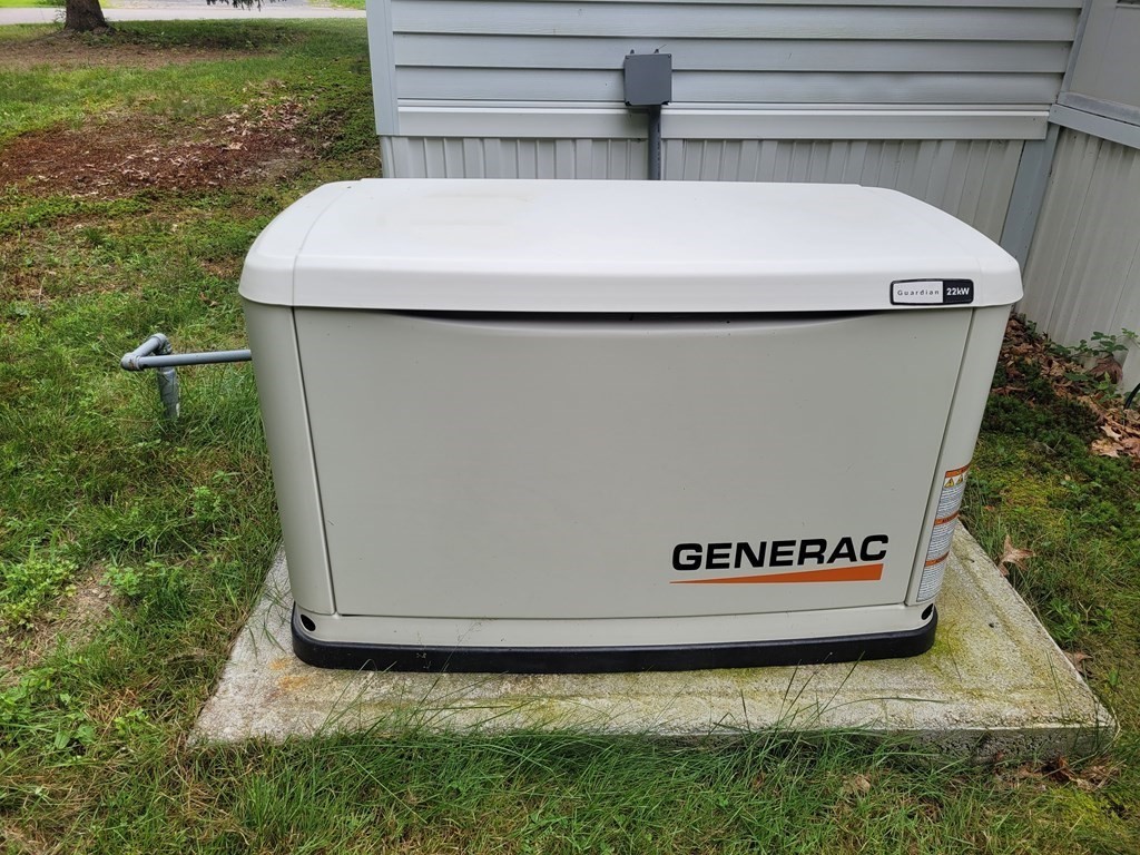 62 Longboat Road Wareham, MA 02576 - Photo 32 of 32 a view of washer and dryer with trees in the background