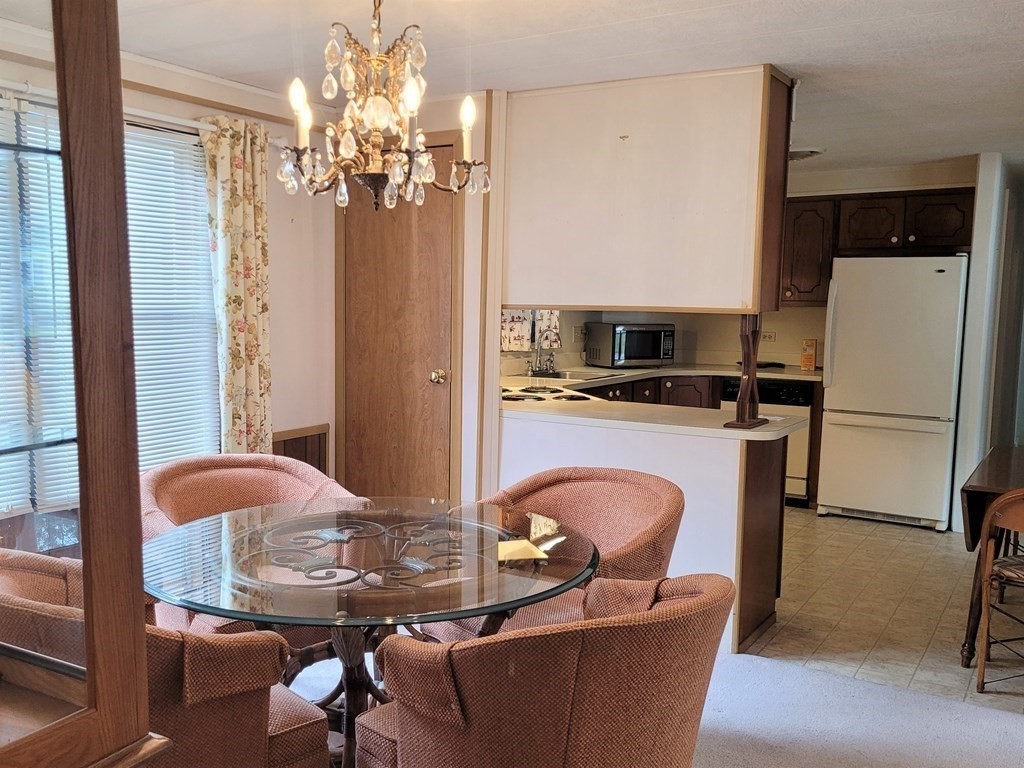 62 Longboat Road Wareham, MA 02576 - Photo 10 of 32 a dining room with furniture and chandelier