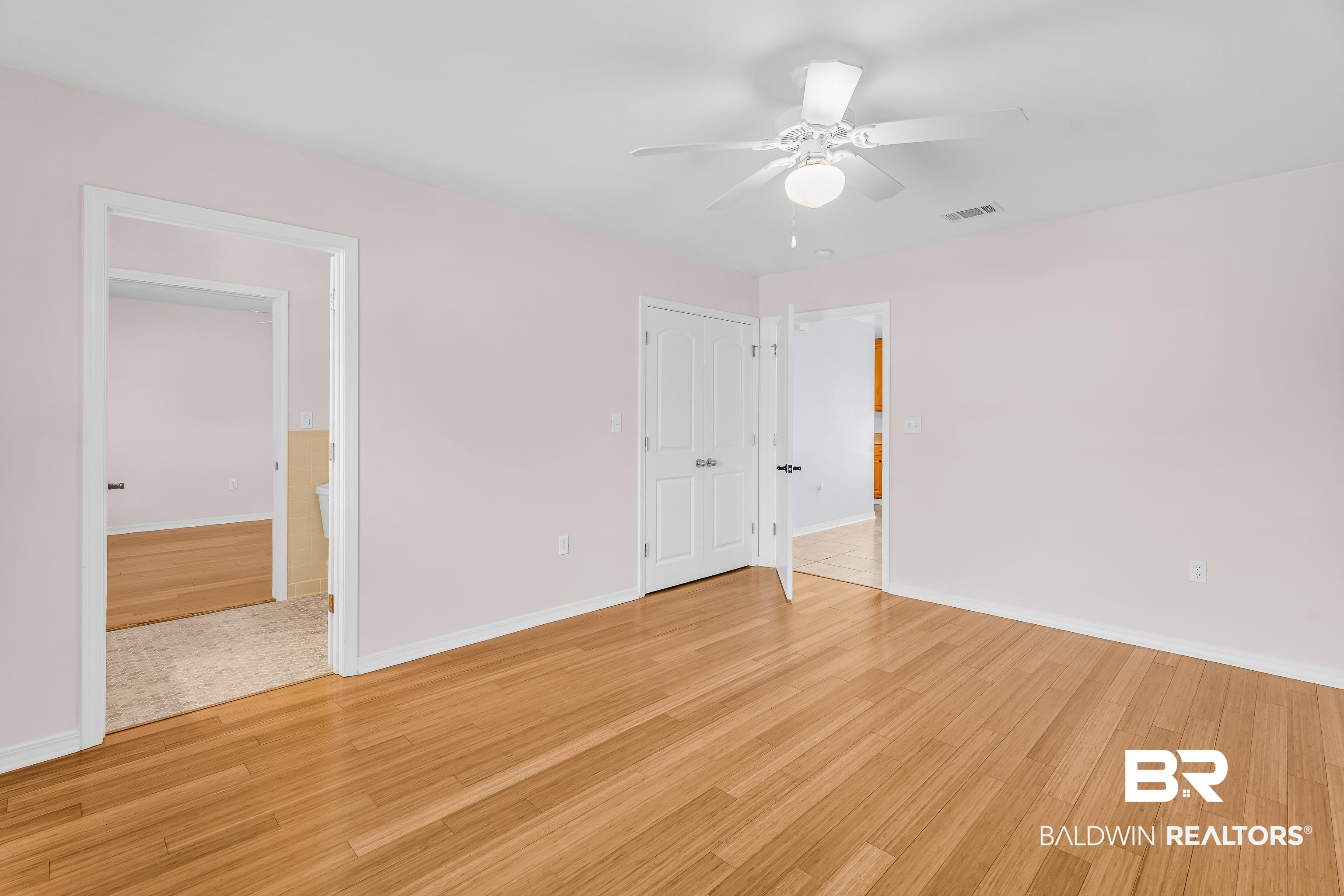 22095 8th Street Silverhill, AL 36576 - Photo 38 of 42 Unfurnished bedroom featuring light wood-type flooring, ceiling fan, and connected bathroom