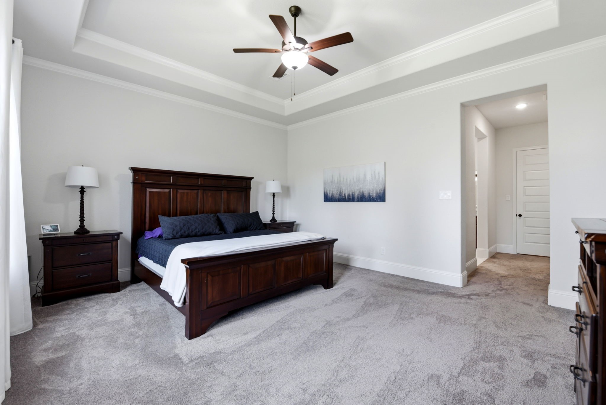 10062 South Goshawk Trail Conroe, TX 77385 - Photo 22 of 43 a bedroom with a bed and a chandelier