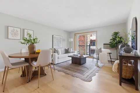 a living room with furniture a window and a table