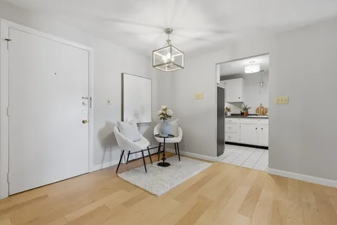 a view of a room with furniture and wooden floor