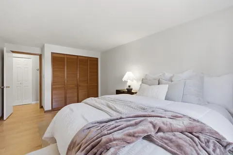 a bedroom with a bed and a closet