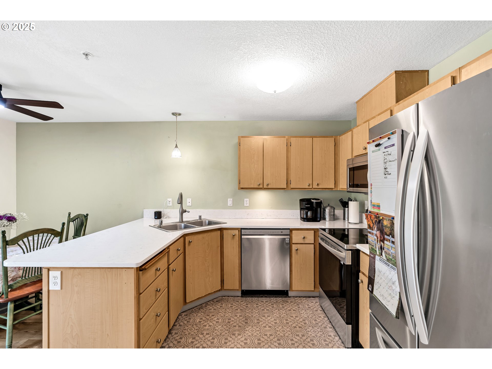 14603 Northeast 20th Avenue, Unit A105 Vancouver, WA 98686 - Photo 12 of 36 a kitchen with a sink a refrigerator and cabinets