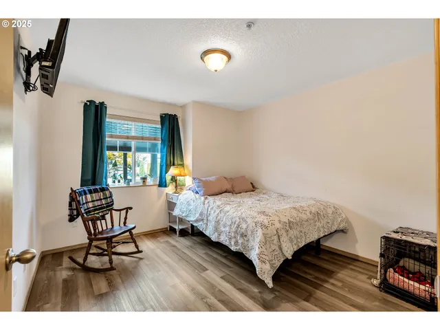 a bedroom with a bed and a desk with chair