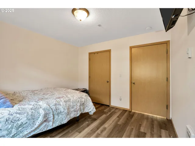 a bedroom with a bed and a television