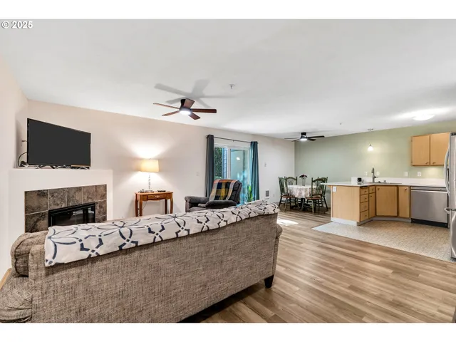 a living room with fireplace furniture and a flat screen tv