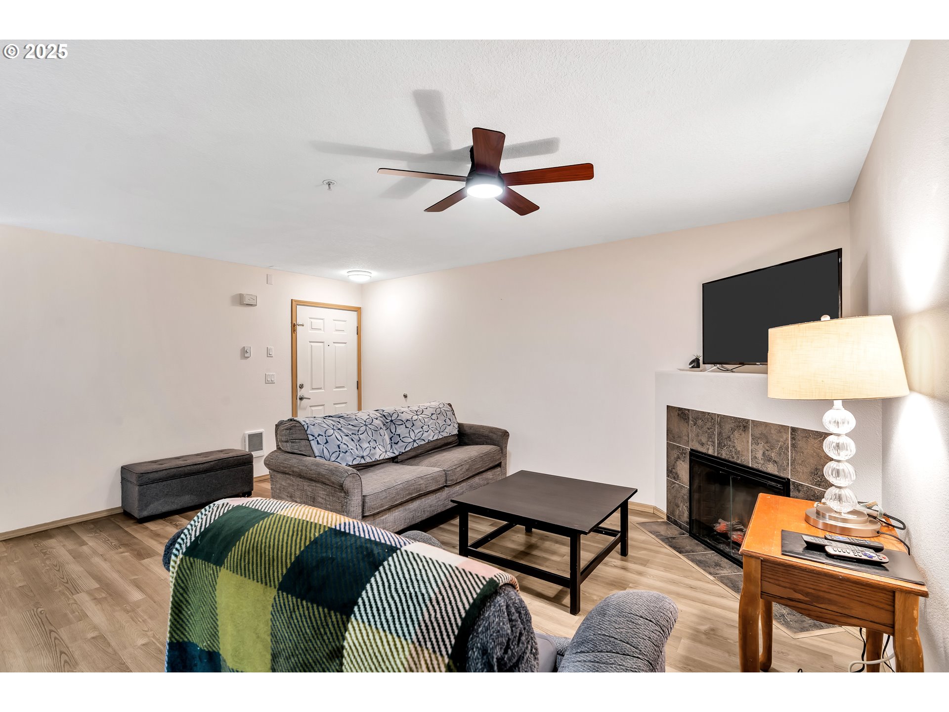 14603 Northeast 20th Avenue, Unit A105 Vancouver, WA 98686 - Photo 9 of 36 a living room with furniture and a fireplace
