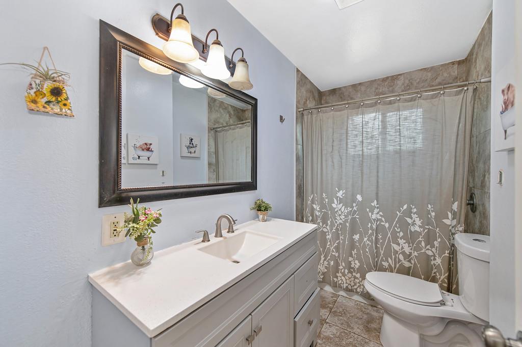 6689 Rhodes Avenue Placerville, CA 95667 - Photo 25 of 60 a bathroom with a sink mirror vanity and toilet