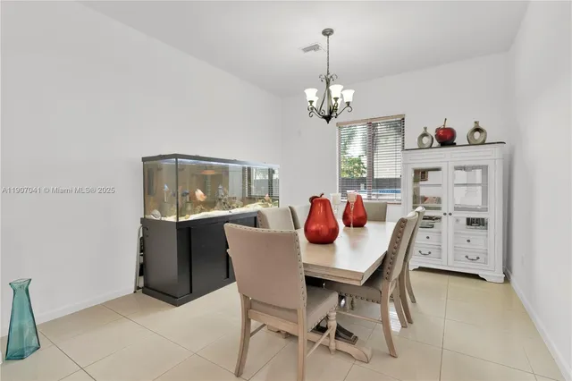 a kitchen with stainless steel appliances granite countertop a dining table chairs stove a sink and dishwasher