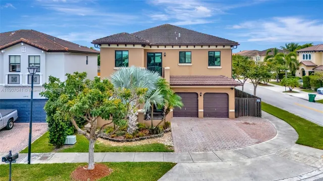 a front view of a house with a garden