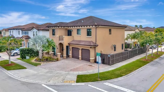 a front view of a house with a garden and yard