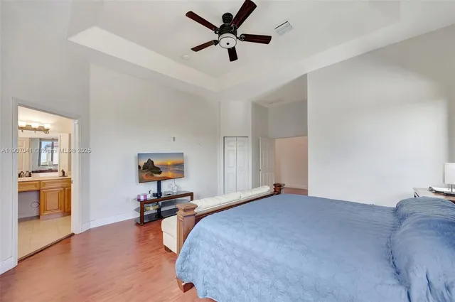 a bathroom with a tub a sink and mirror