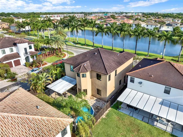 an aerial view of multiple houses with a yard