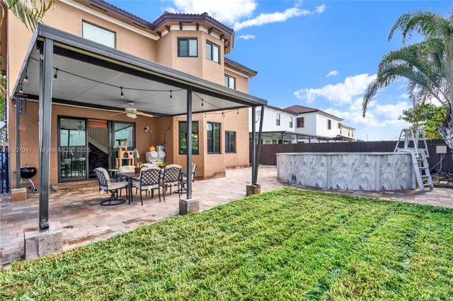 a aerial view of a house with a yard and potted plants