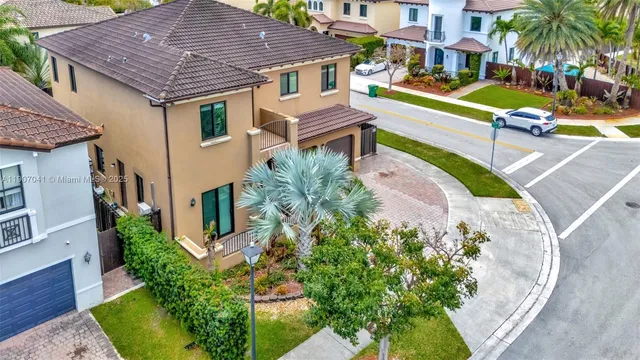 an aerial view of a house with a yard