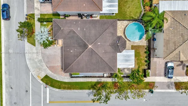 an aerial view of residential houses with outdoor space and river