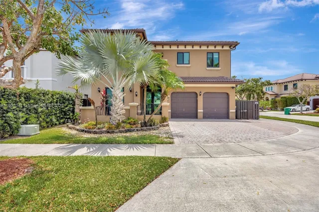 a front view of a house with a garden and plants