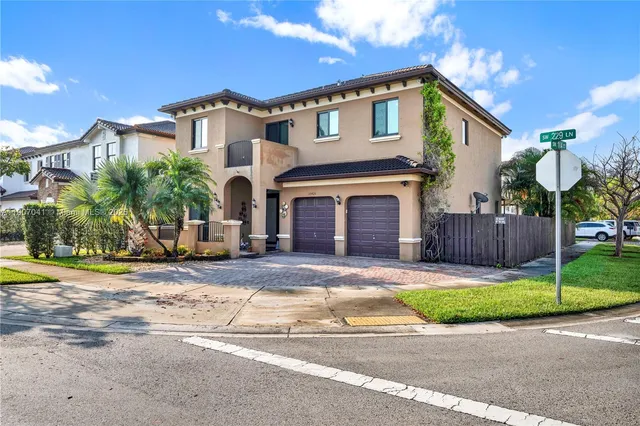 a front view of a house with a yard and garage