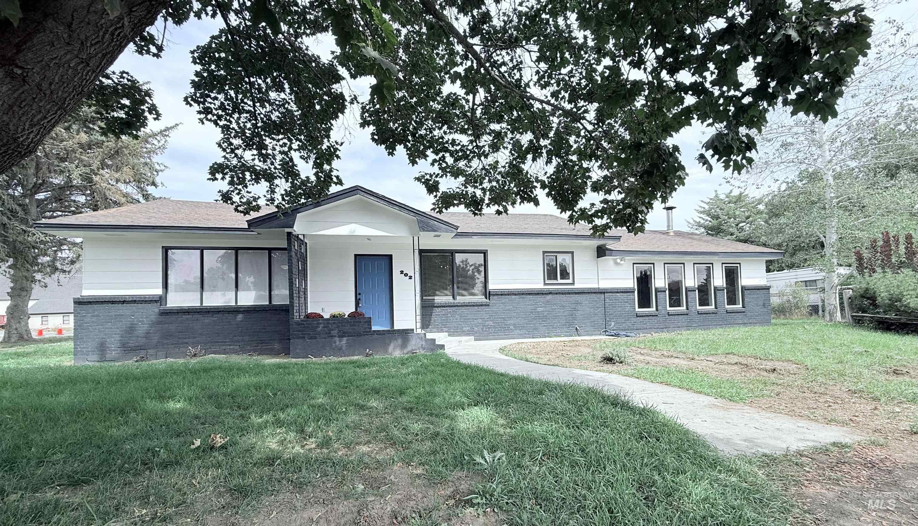 202 East Avenue Wendell, ID 83355 - Photo 1 of 24 Ranch-style home featuring brick siding and a front lawn