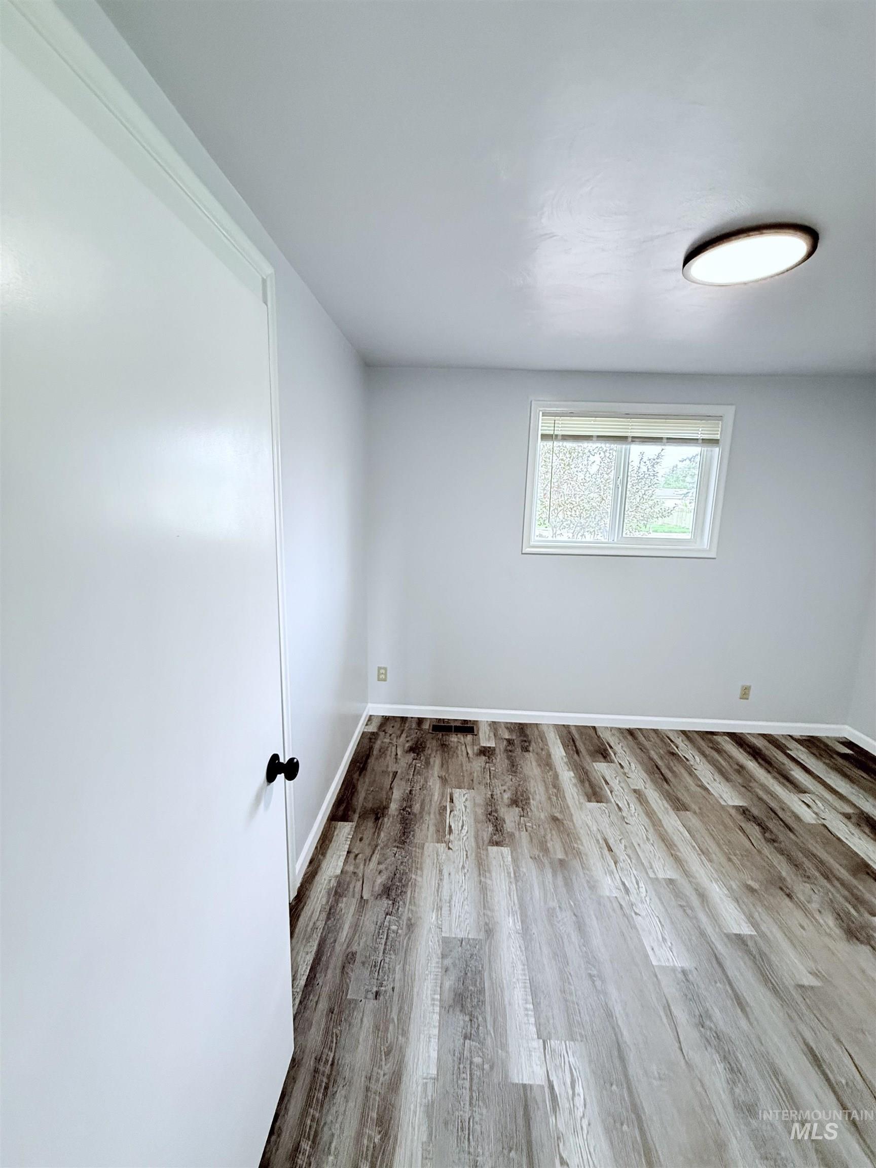 202 East Avenue Wendell, ID 83355 - Photo 12 of 24 Spare room with wood finished floors and baseboards