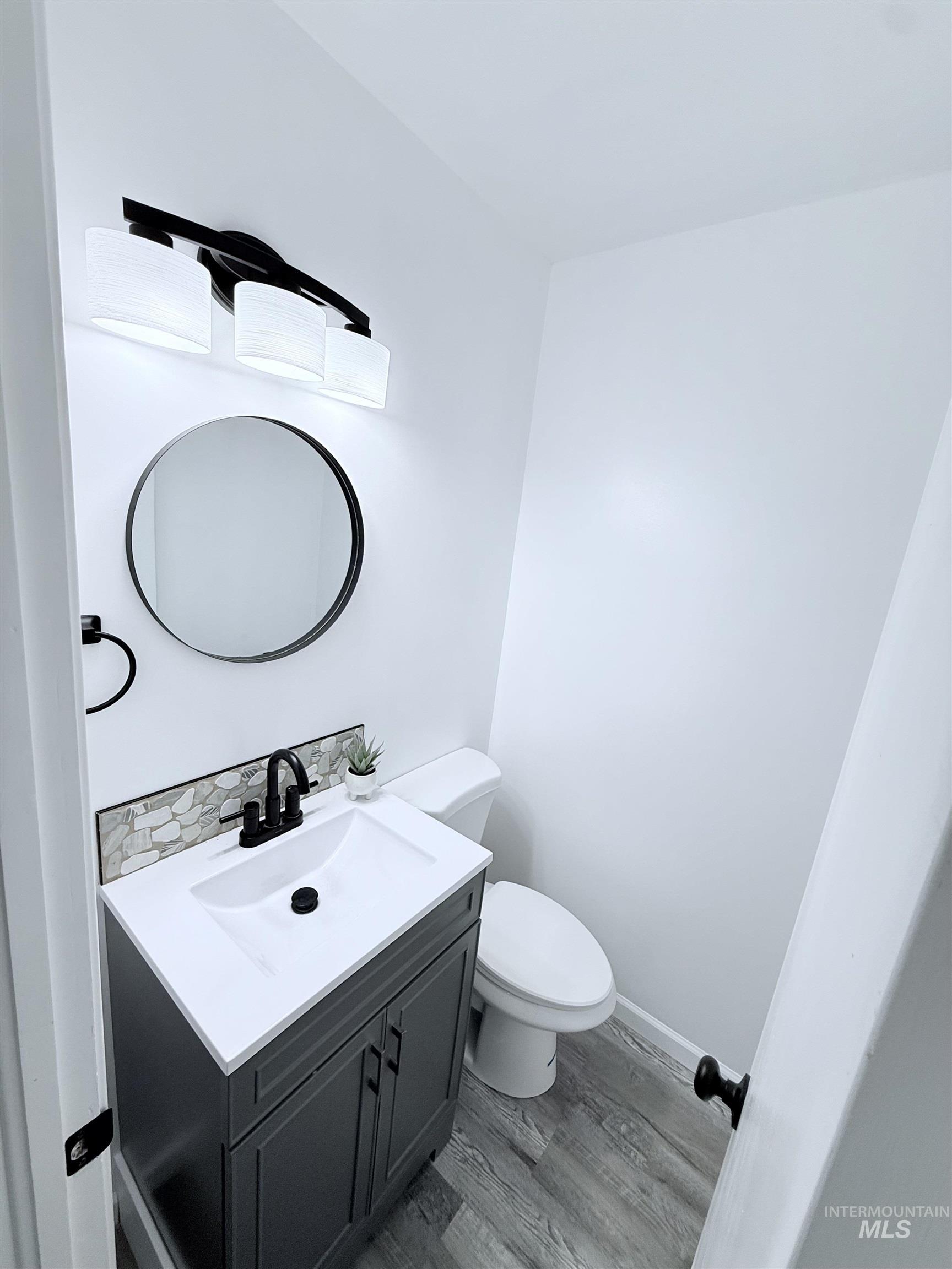 202 East Avenue Wendell, ID 83355 - Photo 13 of 24 Half bath with light wood-style floors and vanity