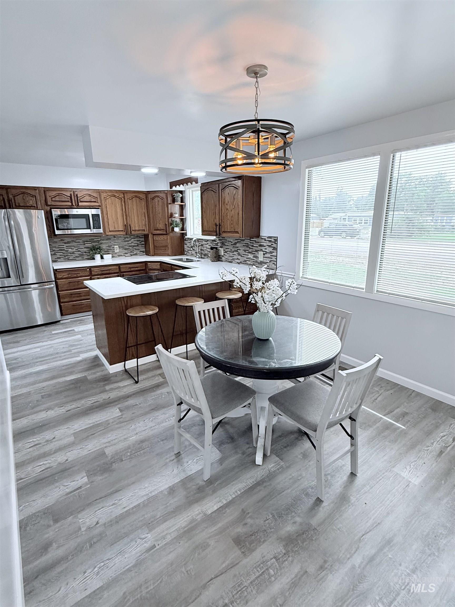 202 East Avenue Wendell, ID 83355 - Photo 4 of 24 Dining space with light wood-style flooring and a chandelier