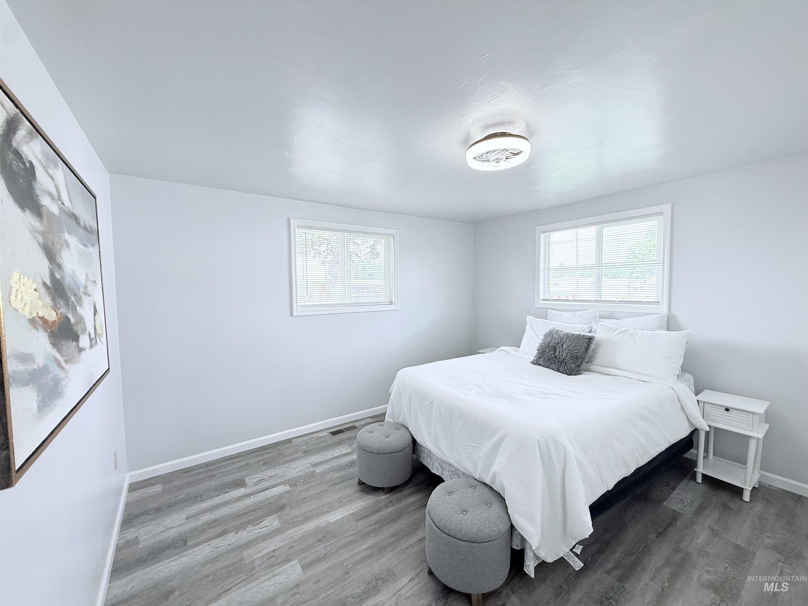 202 East Avenue Wendell, ID 83355 - Photo 8 of 24 Bedroom with wood finished floors and baseboards