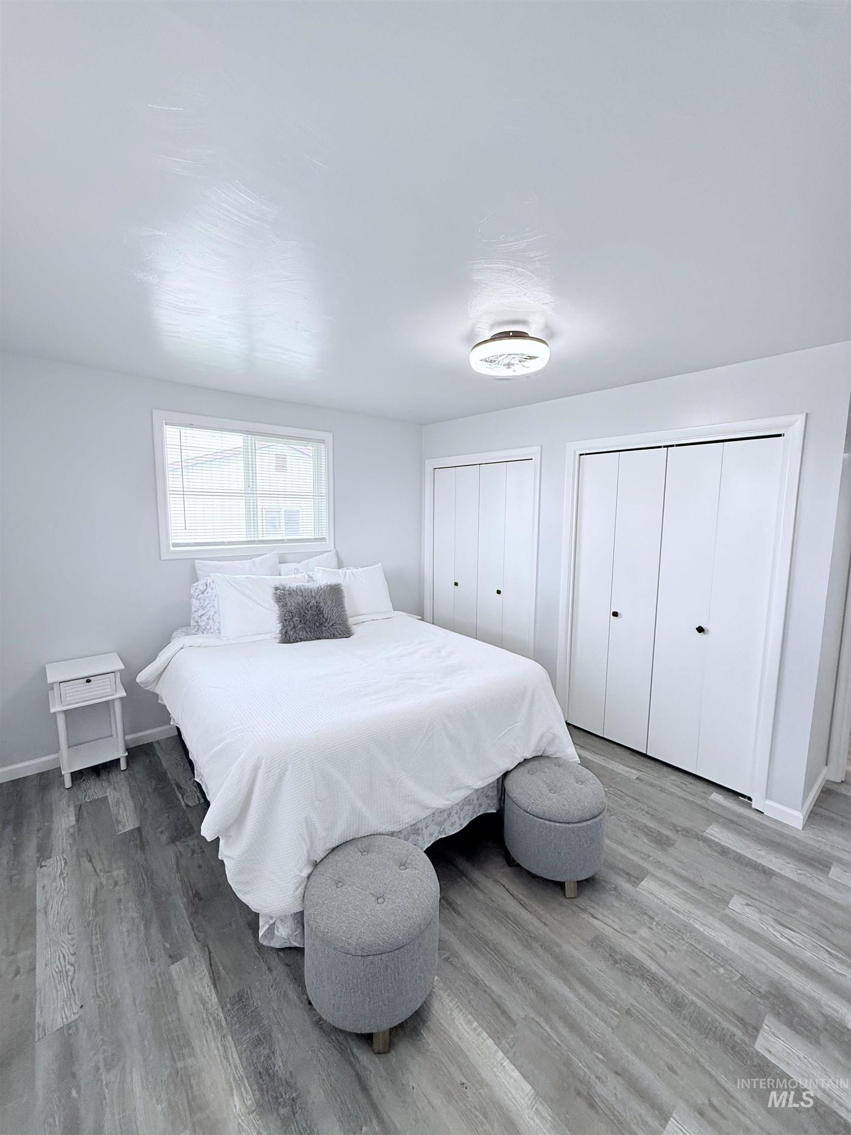 202 East Avenue Wendell, ID 83355 - Photo 9 of 24 Bedroom with multiple closets and wood finished floors