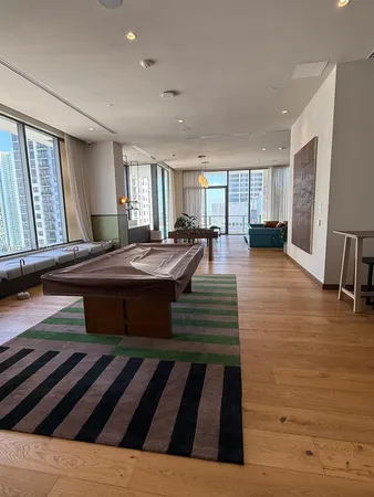 a living room with a bed furniture and a large window