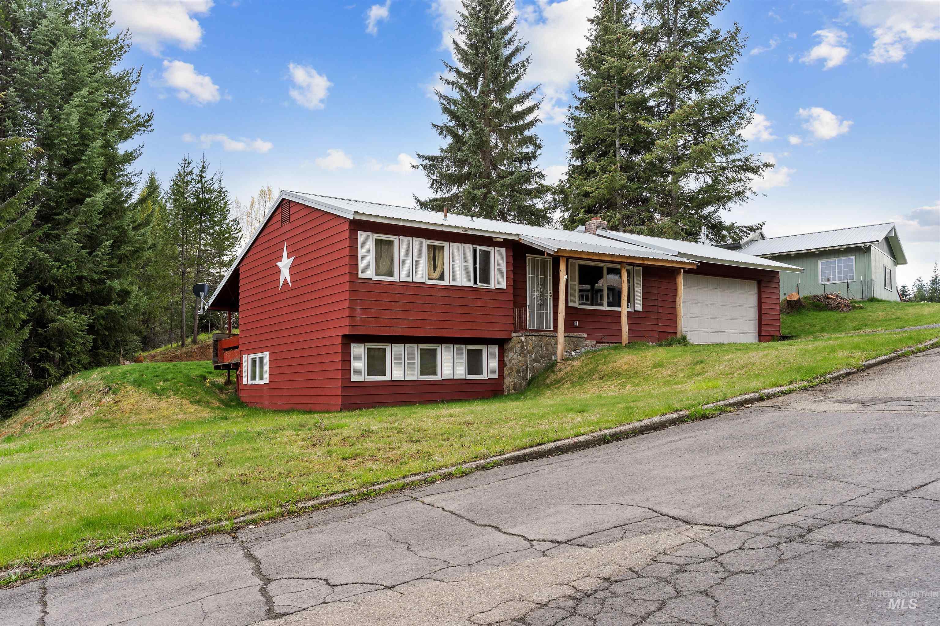 145 Timberline Drive Pierce, ID 83546 - Photo 22 of 39 Red-sided residence featuring a metal roof and an attached garage