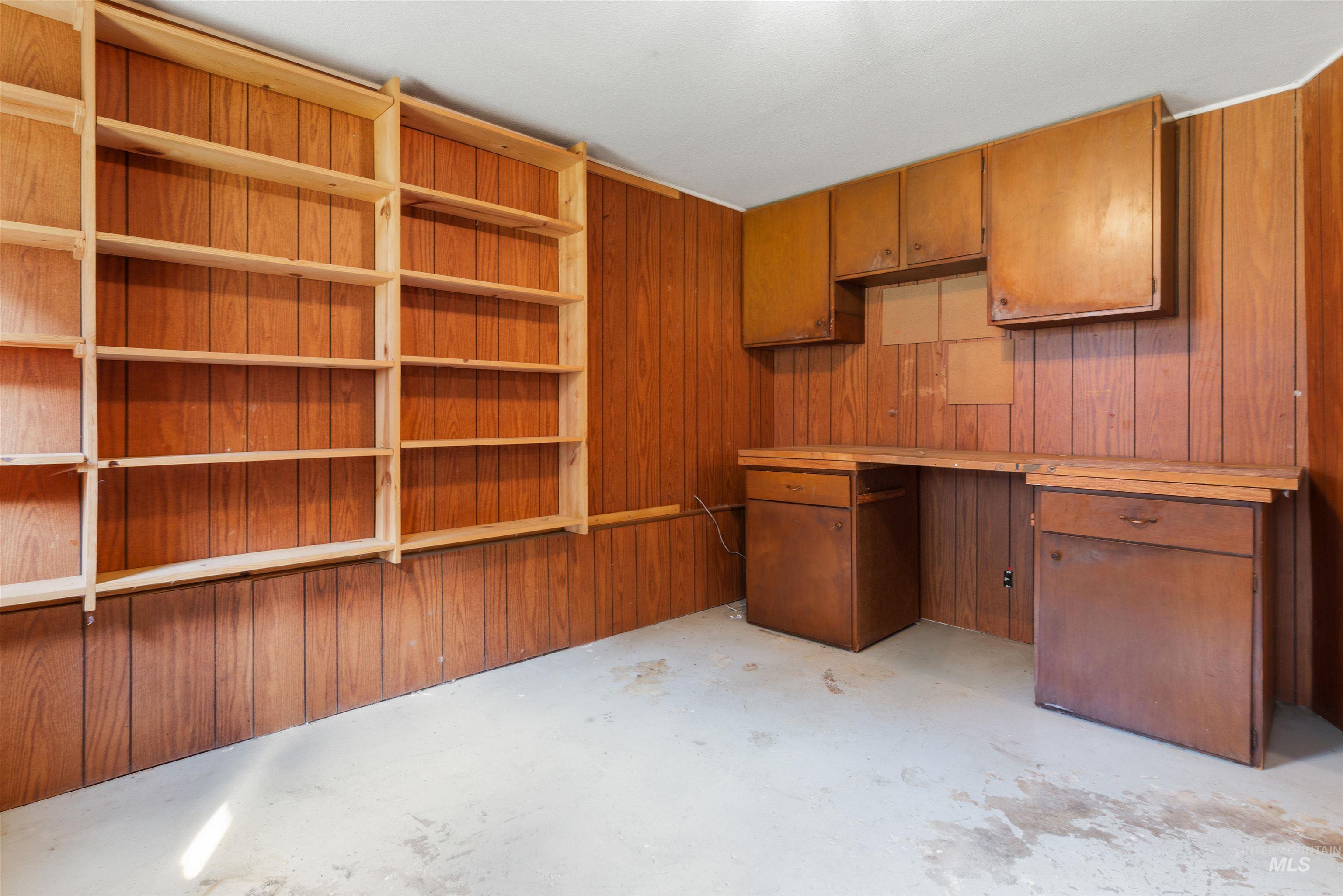 145 Timberline Drive Pierce, ID 83546 - Photo 32 of 39 Built-in wooden shelving and wood-panel accent walls define this versatile space